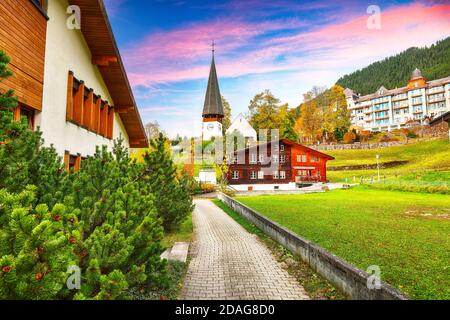 Awesome autumn view of picturesque alpine village Wengen.  Sunny morning scene of Swiss Alps. Location: Wengen village, Berner Oberland, Switzerland, Stock Photo