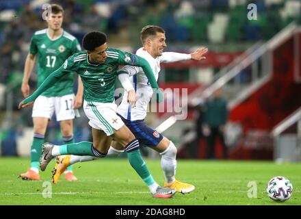 Northern Ireland's Jamal Lewis (left) and Slovakia's Peter Pekarik battle for the ball during the UEFA Euro 2020 Play-off Finals match at Windsor Park, Belfast. Stock Photo