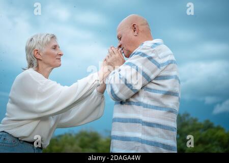 happy senior couple dating, hugging and kissing outdoor Stock Photo