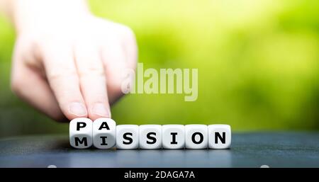 Do your mission with passion. Hand turns dice and changes the name 'mission' to 'passion'. Stock Photo