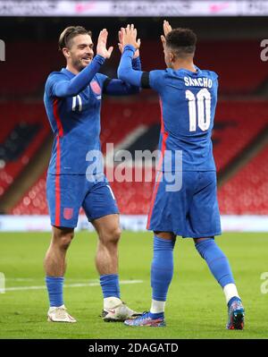 England's Jadon Sancho (right) celebrates scoring his side's second goal of the game with Jack Grealish during the international friendly at Wembley Stadium, London. Stock Photo