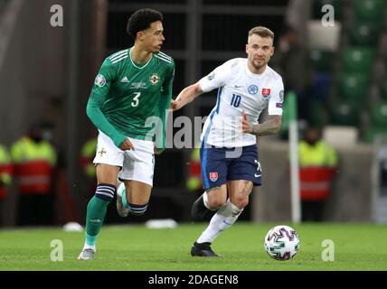 Northern Ireland's Jamal Lewis (left) and Slovakia's Albert Rusnak during the UEFA Euro 2020 Play-off Finals match at Windsor Park, Belfast. Stock Photo