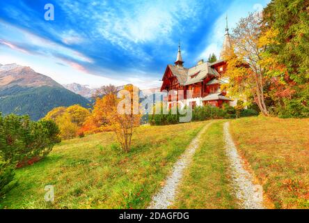 Fantastic autumn view of traditional swiss chalets in Wengen village. Picturesque Alpine village Wengen..  Location: Wengen village, Berner Oberland, Stock Photo