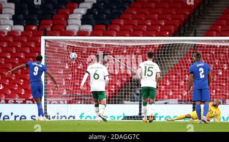 Republic of Ireland goalkeeper Darren Randolph (right) dives in vain as England's Dominic Calvert-Lewin (left) scores his side's third goal of the game from the penalty spot during the international friendly at Wembley Stadium, London. Stock Photo