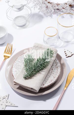 Winter festive table setting with cutlery on table. Christmas tableware. Stock Photo
