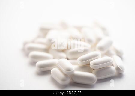 Bunch of little white zinc pills on bright white background Stock Photo
