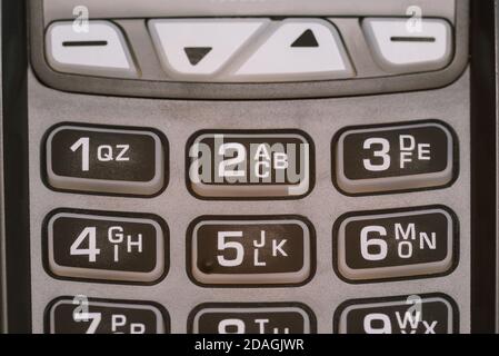 Close-up of the keyboard of a modern payment terminal. Rubber buttons with numbers and letters. Equipment for paying for purchases and issuing a cash Stock Photo