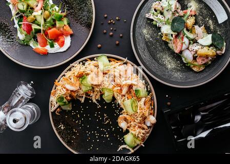 Asian vegetable salad with shrimp on a black background Stock Photo