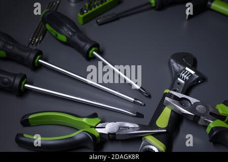 A set of building tools and instruments for repair in black and green colour. Must-have for men. Equipment for building. Repair tool kit. construction concept. gray background . High quality photo Stock Photo