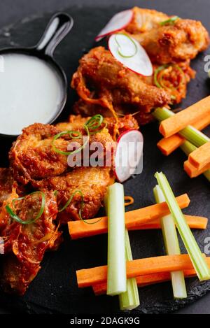Asian-style chicken wings, fresh vegetables Stock Photo