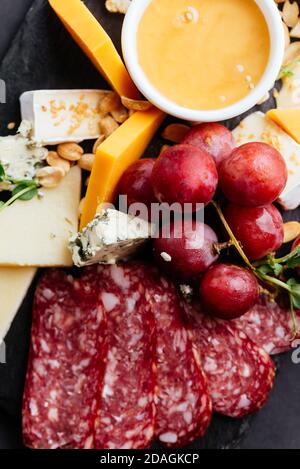 cheese and meat cuts on a black background Stock Photo