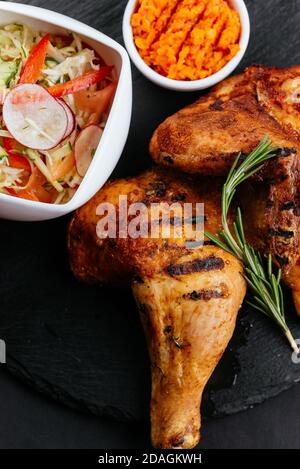 grilled chicken legs with vegetables and sauce Stock Photo