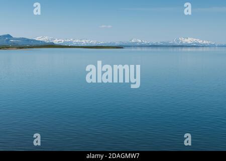 View from Staloluokta over blue water of lake Virihaure towards distant mountains of Norwegian border along Padjelantaleden trail, Padjelanta national Stock Photo