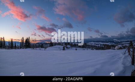 Winter sunset alpine tops  view from mountain village. Picturesque seasonal, nature and countryside beauty concept scene. Stock Photo