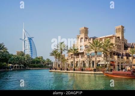 Beautiful view of the famous hotel Burj al Arab. Traditional Arab Dhow sailing on the Bay. Stock Photo