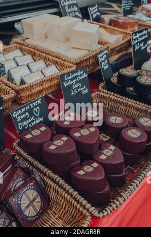 Frome, UK - October 07, 2020: Variety of local cheeses on sale at a street market in Frome, a market town in the county of Somerset famous for its mar Stock Photo