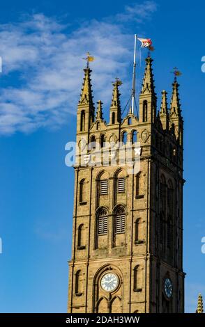 Collegiate Church of St Mary, Warwick. England flag upon a pole waving in the fresh blue sky. Warwickshire, UK. Stock Photo
