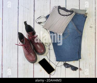 Still life of clothes, denim skirt with dungarees, striped shirt