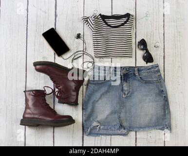 Still life of clothes, denim skirt with dungarees, striped shirt
