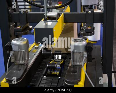 Process of carton forming machine in production line. Warehouse logistics technology Stock Photo