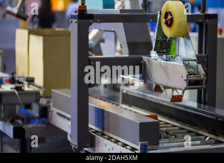 Process of carton forming machine in production line. Warehouse logistics technology Stock Photo