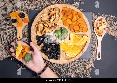 dried fruits on a background of wooden boards. The view from the top. Symbols of the Jewish holiday Tu Bishvat. thanksgiving day. Stock Photo