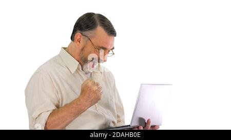 Excited senior business man working on a laptop on white backgro Stock Photo