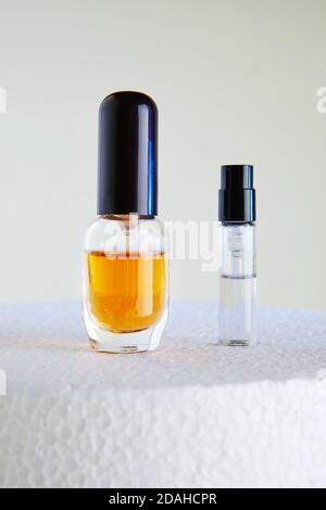 Dropper Bottle for perfume bottles without labels on a white podium. Stock Photo