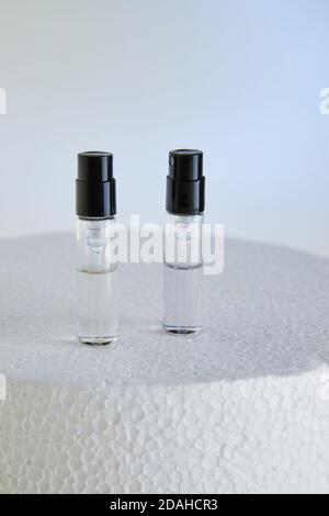 Dropper Bottle for perfume bottles without labels on a white podium. Stock Photo