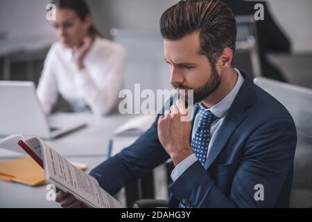 Business man attentively examining documents in office Stock Photo
