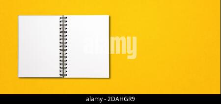 Blank open spiral notebook mockup isolated on yellow horizontal banner Stock Photo