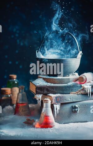 Couldron with winter and snow, witch potion concept, magical still life with Stock Photo