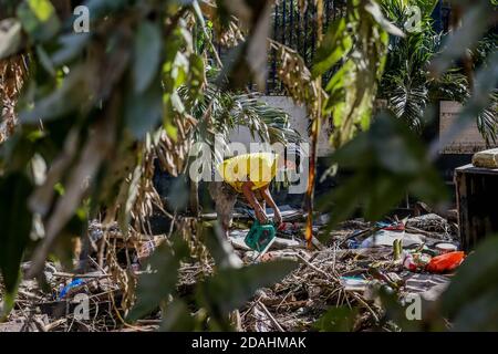 Manila, Philippines. 13th Nov, 2020. A resident looks for his belongings after the flood brought by Typhoon Vamco in Manila, the Philippines, Nov. 13, 2020. The Philippine government said on Friday that Typhoon Vamco, which has caused devastating floods and landslides in the main island of Luzon, has killed at least 14 people, officials said. Credit: Rouelle Umali/Xinhua/Alamy Live News Stock Photo