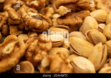 Pistachios and walnuts lie on the sacking. Close up Stock Photo