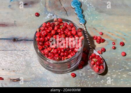 Pink Round Peppercorn. Isolated. Copy Space. Vibrant pink round peppercorns in a glass jar. Focus in the centre. Stock Image. Stock Photo