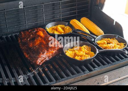 slow grilling of ribs with bacon on the grill Stock Photo