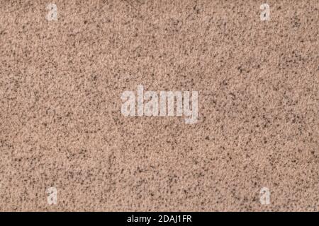 Light brown fluffy background of soft, fleecy cloth. Texture of beige wool textile backdrop, closeup. Stock Photo