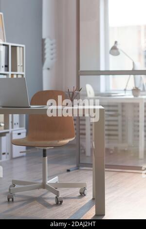 Image of modern workplace with laptop on it at empty office Stock Photo