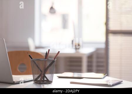 Close-up of desk with laptop digital tablet and notepad on it at the office Stock Photo