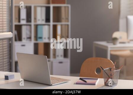 Image of laptop on empty desk at modern empty office Stock Photo