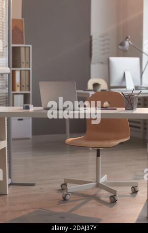 Image of empty workplace of businessman with laptop at modern empty office Stock Photo