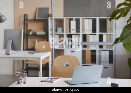 Image of desk with laptop for online work on it at modern office Stock Photo
