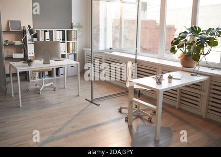 Image of empty office with tables and computers on them arranging for work Stock Photo