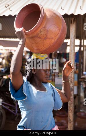 Selingue, Mali, 25th April 2015; Noumou Sira, a potter, sells her large pots for 1,000 to 1250 CFA each.  She can make 4 per day and fires 20 pots at the same time.  The wood for the kiln costs her 10,000 CFA. Stock Photo