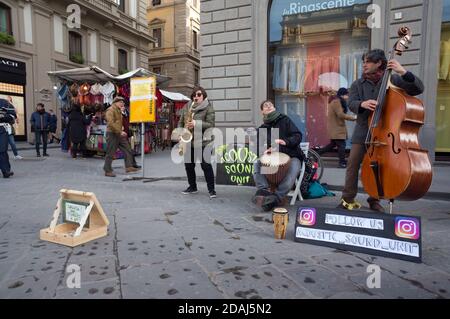 A trio of musicians make money on the tourist shopping street of the city. Stock Photo