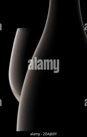silhouette of a wine bottle and glass on black background Stock Photo