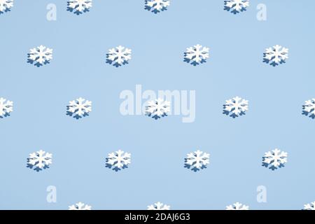 White snowflakes pattern on blue background. Christmas, winter holidays, New year concept. Minimal style. Stock Photo