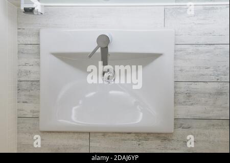 New clean bathroom tap with white shiny faucet above view Stock Photo