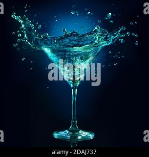 martini cocktail splashing in a dark blue background Stock Photo