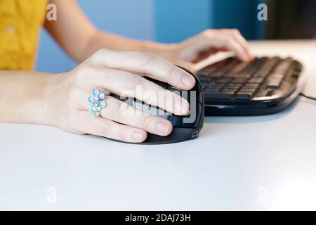 Close up of woman using mouse and computer keyboard working from home Stock Photo